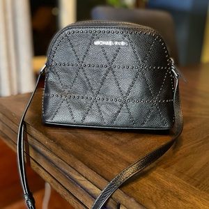 Lightly used Michael Kors small handbag with long adjustable strap in charcoal